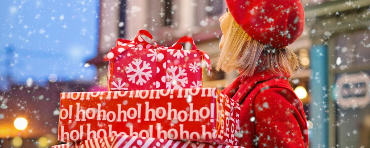 Woman in red carrying gifts while it's snowing